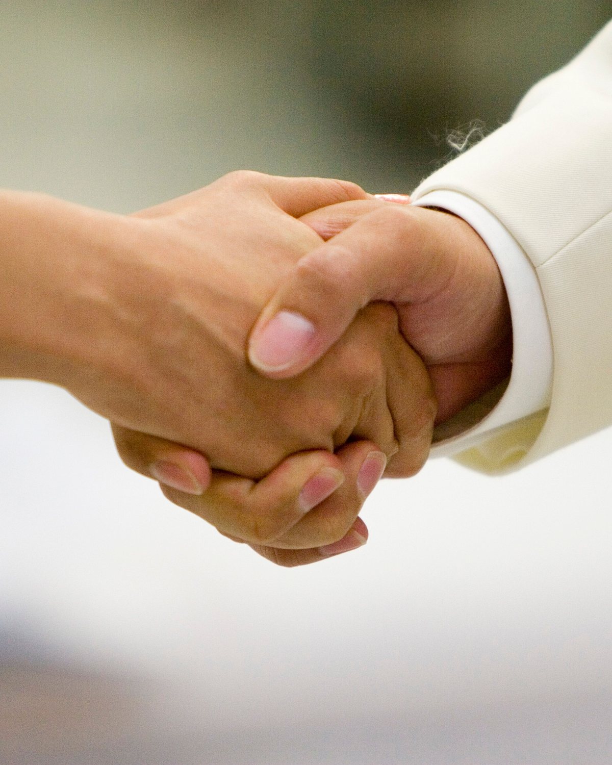 Two business people shaking hands after agreeing a facility services scope